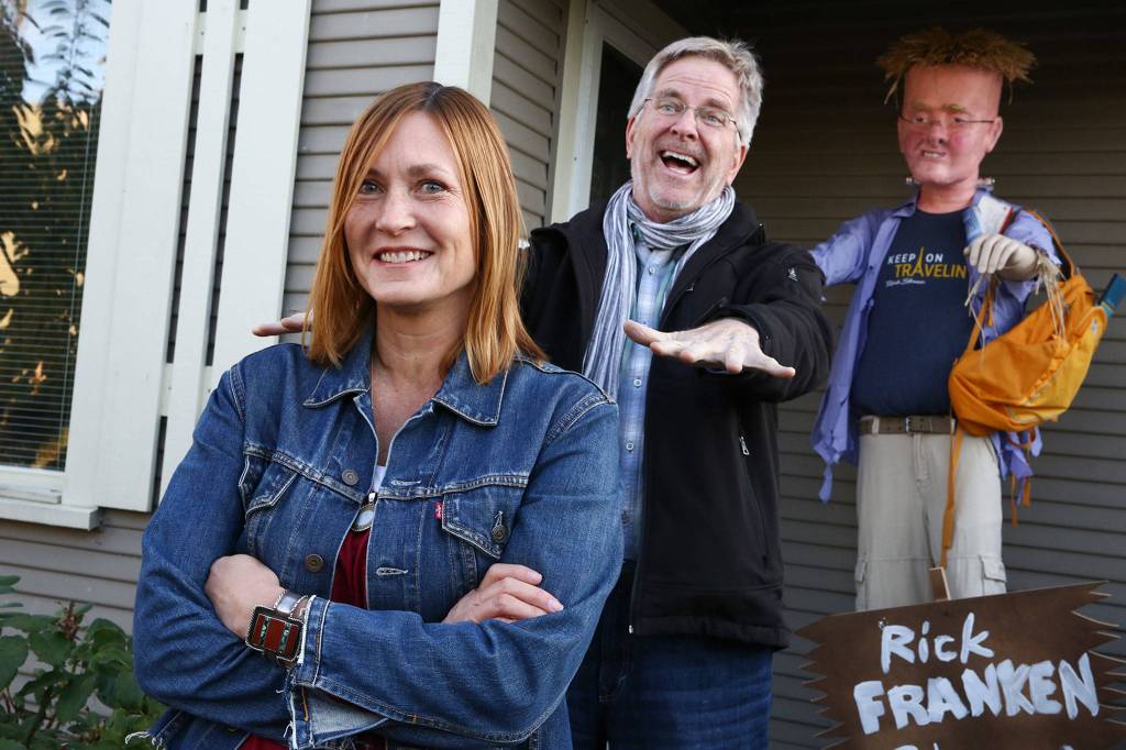 Marjie Bowker (left) along with her boyfriend created a scarecrow of local celebrity Rick Steves (right) for a citywide contest in Edmonds. (Kevin Clark / The Herald)