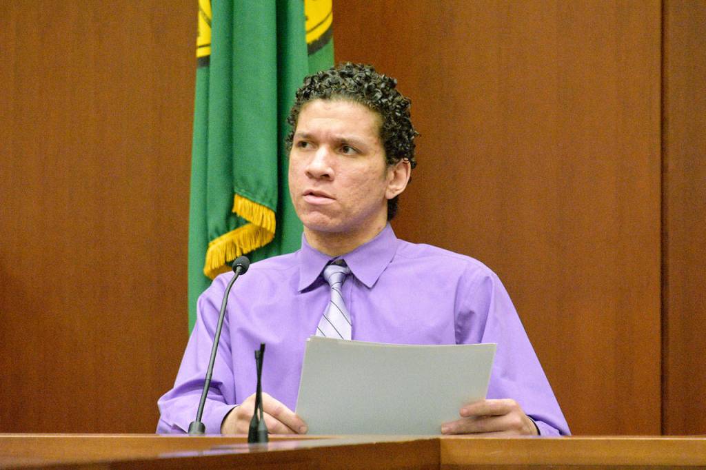Matthew McGowan answers questions Friday about photographed evidence in his murder trial in Snohomish County Superior Court. McGowan is accused of beating homeless man Michael Boone, tying him to a tree and leaving him to die in freezing weather. (Caleb Hutton / The Herald)