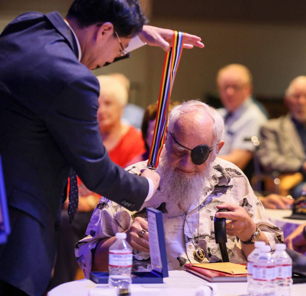 Consul General Hyung-jong Lee presents the Ambassador for Peace Medal to Freeman Nickel for his service in the Korean War Monday morning at Northwest Church in Lynnwood. (Kevin Clark / The Herald)