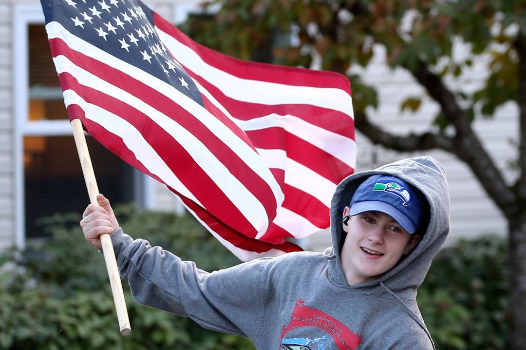 Josh Bagocki along with others run the streets of Granite Falls in support of veterans mental health and support Friday afternoon in Granite Falls. (Kevin Clark / The Herald)