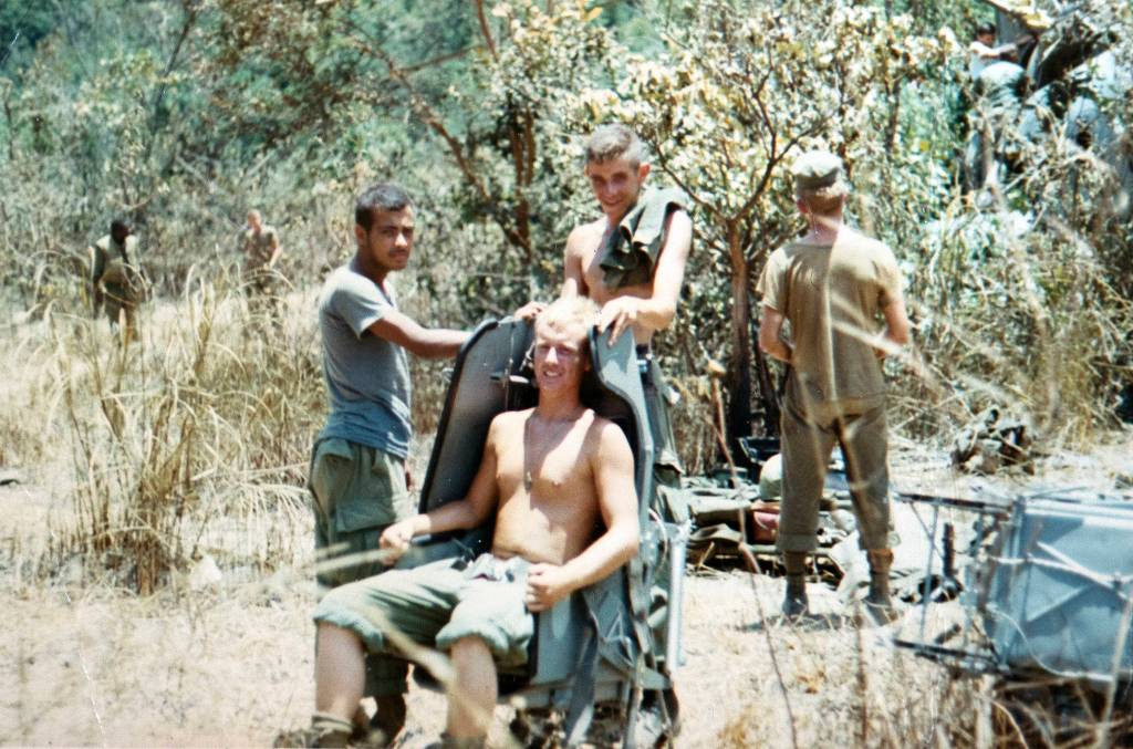 Greg Doering sits in a seat as he and his squad pull security duty while recovering parts from a downed helicopter in Vietnam. (Photo courtesy of Greg Doering)