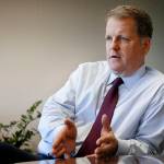 In this 2013 photo, U.S. Airways CEO Doug Parker responds to a reporters question during an interview at AMR headquarters in Fort Worth, Texas. (AP Photo/Tony Gutierrez, File)