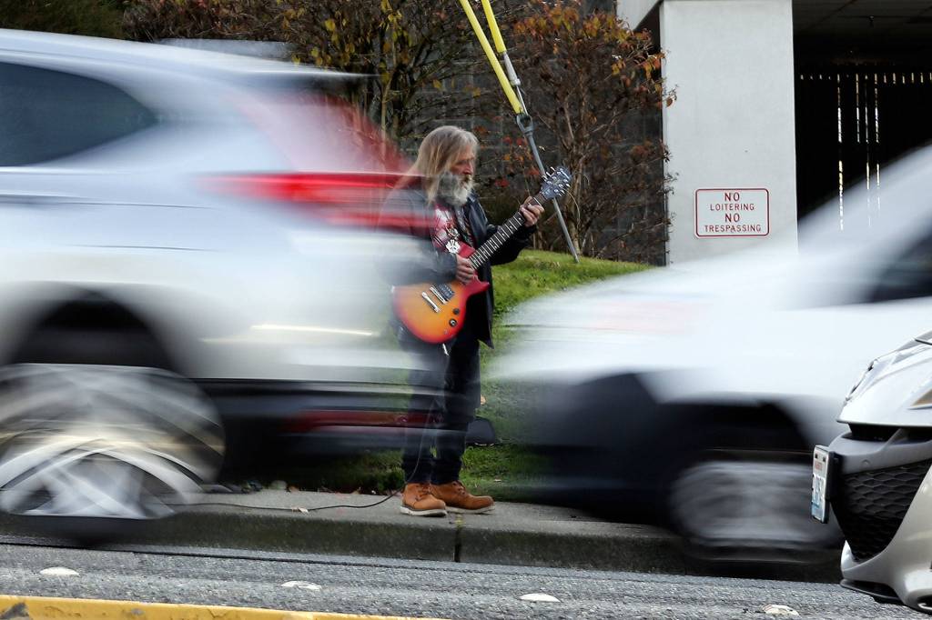 Jim Morris is a guitar-playing fixture at the corner of 164th Street SW and Ash Way in Lynnwood. (Kevin Clark / The Herald)