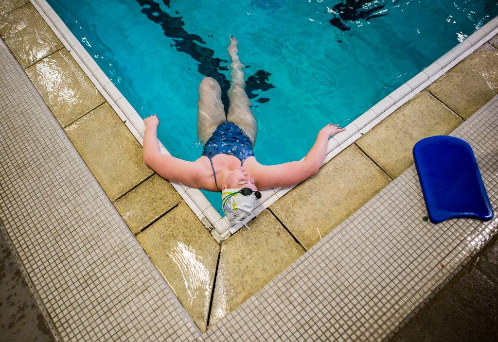 Lake Stevens Grace Brown rests in the corner of the pool after an exercise during swim practice at Explorer Middle School on Nov. 6, 2019 in Everett, Wash. (Olivia Vanni / The Herald)