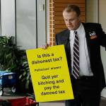 Anti-tax activist Tim Eyman holds a sign as he prepares to talk to reporters Thursday outside the office of Seattle Mayor Jenny Durkan in Seattle. (AP Photo/Ted S. Warren)