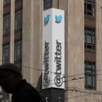 A pedestrian walks across the street from the Twitter office building in San Francisco. (AP Photo/Jeff Chiu, File)