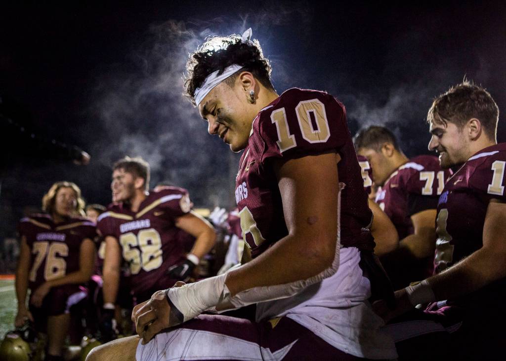 Lakewoods Landen Pruitt smiles in the huddle after winning a 2A playoff game against Liberty on Nov. 8, 2019 in Arlington, Wash. (Olivia Vanni / The Herald)