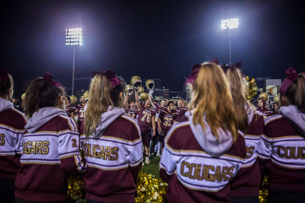 The Lakewood High School cheer staff watches as the football team sings their fight song after a 2A playoff game against Liberty on Nov. 8, 2019 in Arlington, Wash. (Olivia Vanni / The Herald)