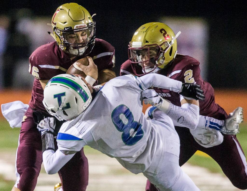 Lakewoods Carson Chrisman tackles Libertys Tate Hayden as Lakewoods Jared Taylor runs the ball during a 2A playoff game against Liberty on Nov. 8, 2019 in Arlington, Wash. (Olivia Vanni / The Herald)