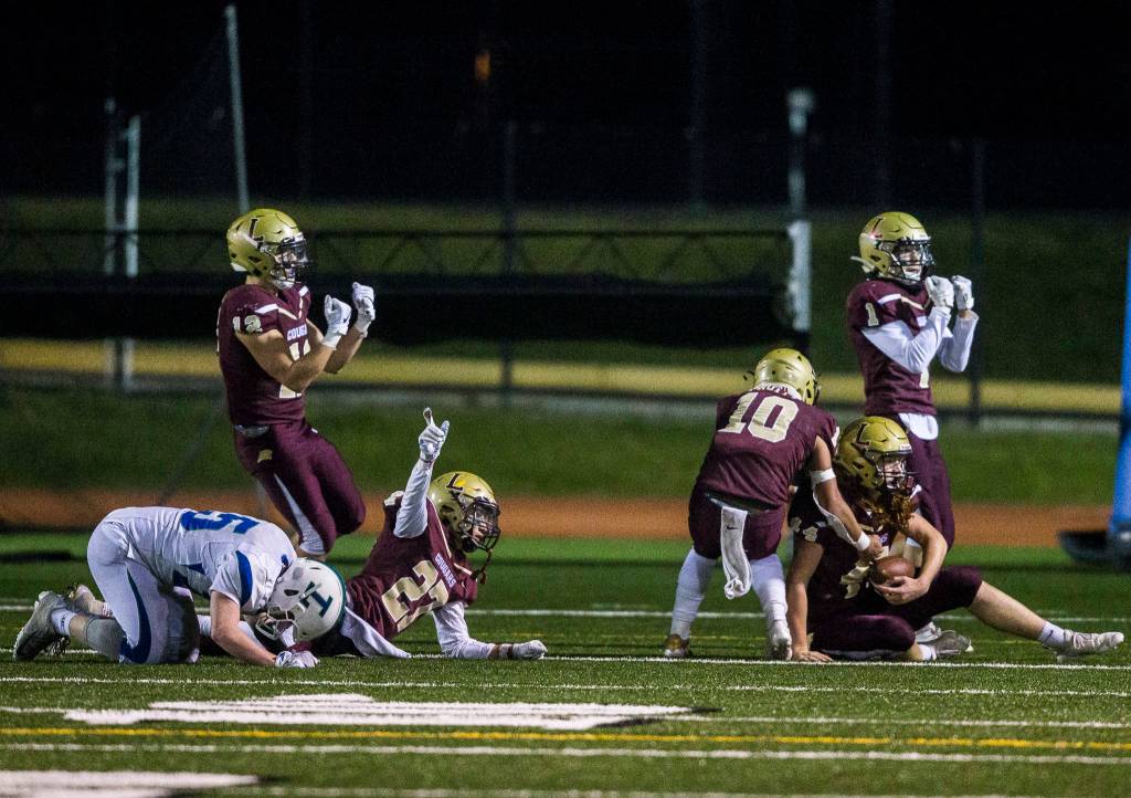 Lakewood players look for the interception signal from the referees after Lakewoods Andrew Molloy intercepts the blocked pass in the end zone during a 2A playoff game against Liberty on Nov. 8, 2019 in Arlington, Wash. (Olivia Vanni / The Herald)