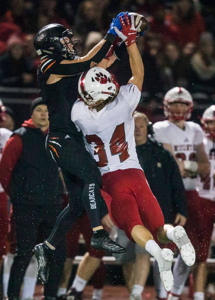 Monroes Efton Chism III jumps above Mount Sis Daniel Harrison to make a catch during the 4A playoff game against Mount Si on Nov. 9, 2019 in Monroe, Wash. (Olivia Vanni / The Herald)