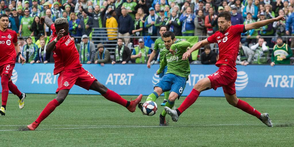 Sounders midfielder Víctor Rodríguez scores the second goal between two Toronto defenders as the Seattle Sounders beat Toronto FC 3-1 to win the MLS Cup at CenturyLink Field on Sunday, Nov. 10, 2019 in Seattle, Wash. (Andy Bronson / The Herald)