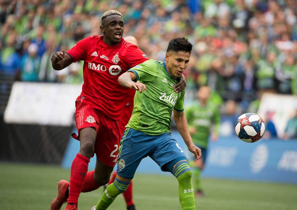 Toronto defender Chris Mavinga tries to stop Sounders forward Raúl Ruidíaz from scoring a goal. Ruidiaz scored and the Seattle Sounders beat Toronto FC 3-1 to win the MLS Cup at CenturyLink Field on Sunday, Nov. 10, 2019 in Seattle, Wash. (Andy Bronson / The Herald)