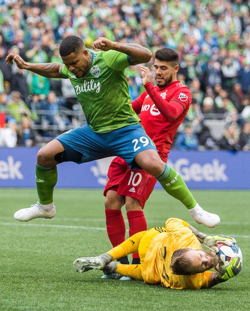 Sounders defender Román Torres jumps over Sounders goalkeeper Stefan Frei during the MLS Cup on Nov. 10, 2019 in Seattle, Wash. (Olivia Vanni / The Herald)