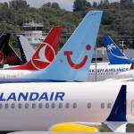Dozens of grounded Boeing 737 Max airplanes crowd a parking area adjacent to Boeing Field in Seattle in June. (AP Photo/Elaine Thompson, File)