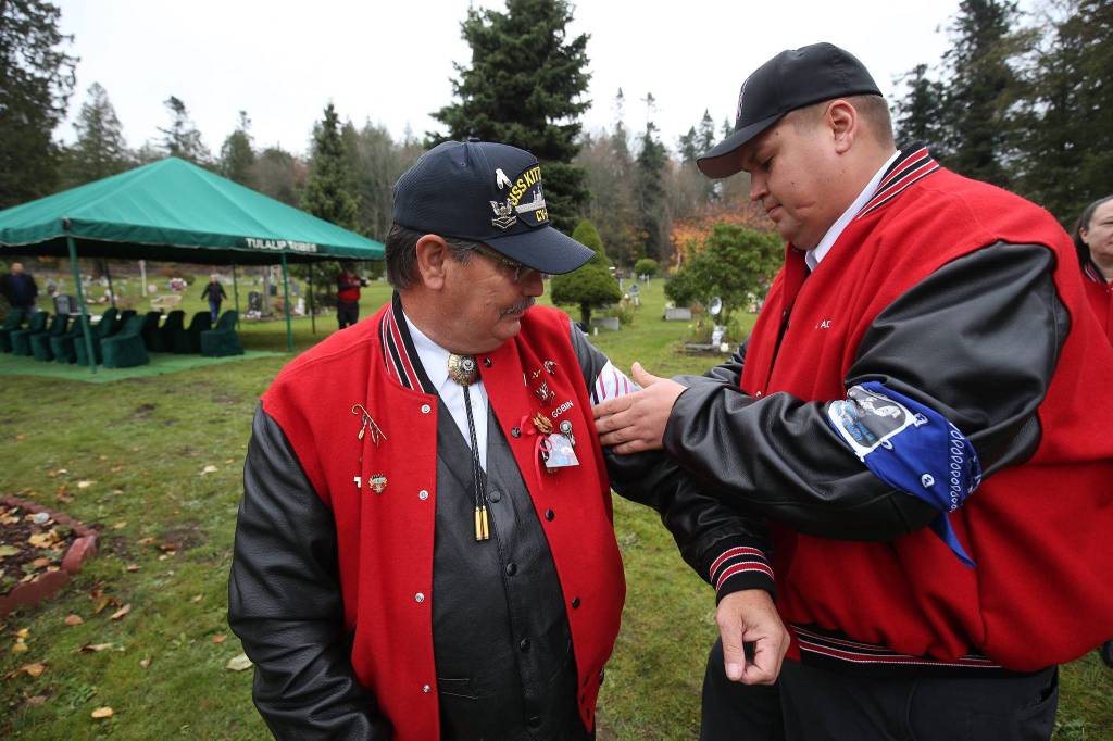 Mike Gobin (left) has his armband straightened by Mike Addie before the funeral for Stan Jones, the Tulalip Tribes longest serving board member and chairman, on Tuesday. (Andy Bronson / The Herald)