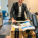Joseph Alonzo, CEO of Cocoon House, moves a cartload of books arriving from Amazon.
