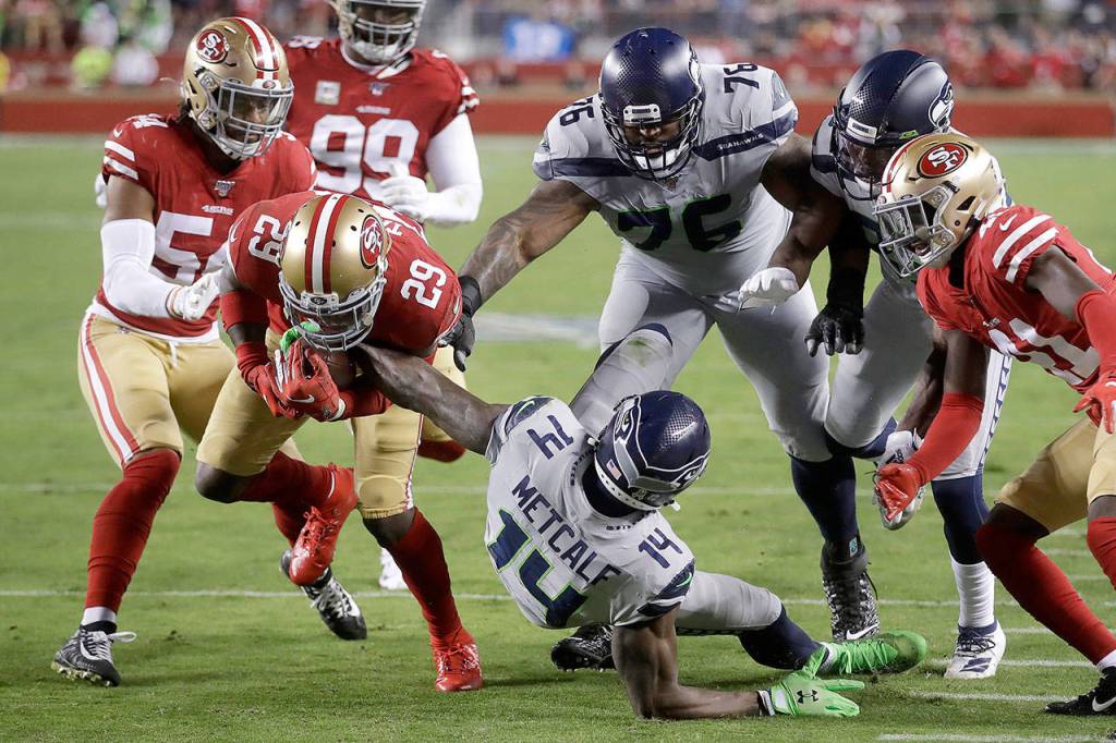 San Francisco 49ers strong safety Jaquiski Tartt (29) strips the ball from Seattle Seahawks wide receiver D.K. Metcalf (14) during the first half of an NFL football game in Santa Clara, California, on Monday. (AP Photo/Ben Margot)