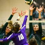 Jacksons Ainsley Johanson (left) and Erin Ingram attempt a block on North Creeks Allison Wilks. (Kevin Clark / The Herald)