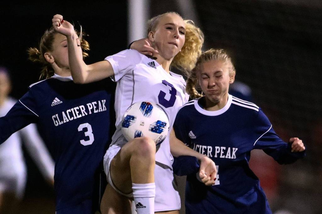 Glacier Peaks Chloe Seelhoff (right) and Annika Lambott (right) fight with Sumners Madison Morgan for control Wednesday evening at Glacier Peak High School in Snohomish on November 13, 2019. Sumner won 2-1. (Kevin Clark / The Herald)