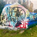 This week, the Epstein slogan on the Snohomish rock was tagged over with NATO graffiti using the anarchy sign for the letter A. (Andrea Brown / The Herald)