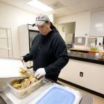 Jeannie Dalton, co-owner of Firewater Events, scoops dried limes into a container while renting the PNW Commissary Kitchen in Marysville. (Andy Bronson / The Herald)                                Jeannie Dalton, co-owner of Firewater Events, scoops dried limes into a container while using the PNW Commissary Kitchen on Monday, Nov. 18, 2019 in Marysville, Wash. (Andy Bronson / The Herald)