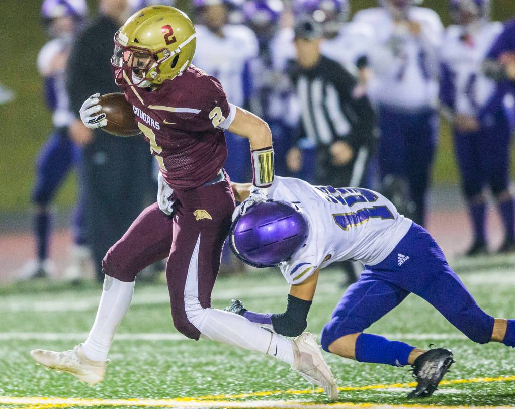 Lakewoods Carson Chrisman runs though the tackle of a Sequim defender during a 2A state playoff game on Friday in Arlington. (Olivia Vanni / The Herald)