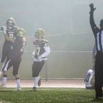 Lakewoods Carson Chrisman (with football) celebrates with teammates Jackson Schultz (7) and Hayden Richardson (97) after scoring a touchdown during a 2A state playoff game on Friday in Arlington. (Olivia Vanni / The Herald)