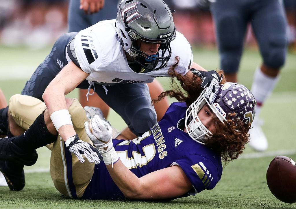 Unions Daron Ulrich and Lake Stevens Xander Fogel continue after a downed ball Saturday afternoon at Lake Stevens High School on November 16, 2019. Lake Stevens won 28-21. (Kevin Clark / The Herald)