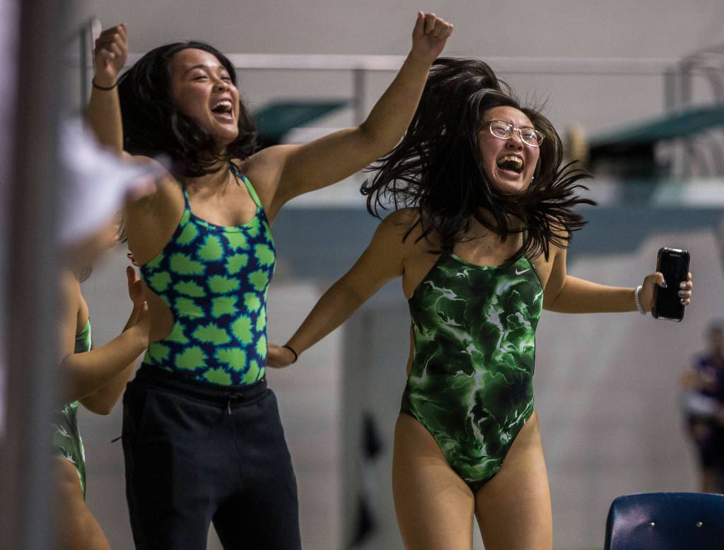 Jackson swimmers cheer on their teammates during the 2019 4A Girls State Swim and Dive Championship on Nov. 16, 2019 in Federal Way, Wash. (Olivia Vanni / The Herald)