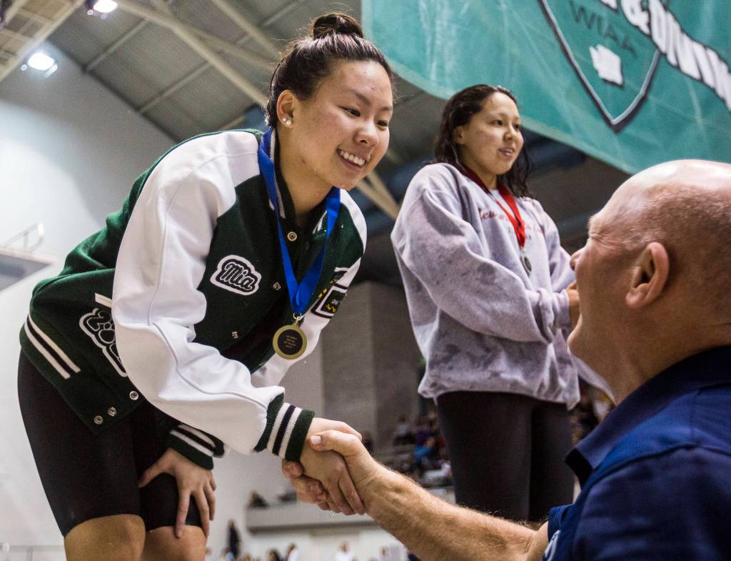 Jacksons Mia Chang receives her first place medal for the 200 yard IM during the 2019 4A Girls State Swim and Dive Championship on Nov. 16, 2019 in Federal Way, Wash. (Olivia Vanni / The Herald)