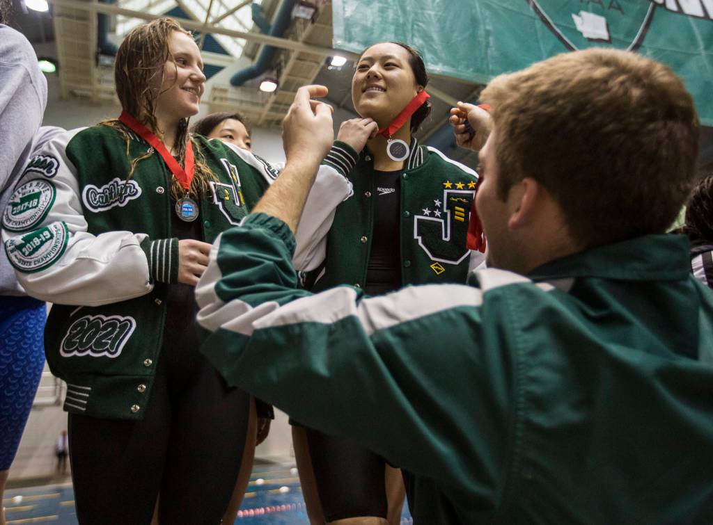 Members of Jacksons 200 freestyle relay team receive their second-place medals. (Olivia Vanni / The Herald)