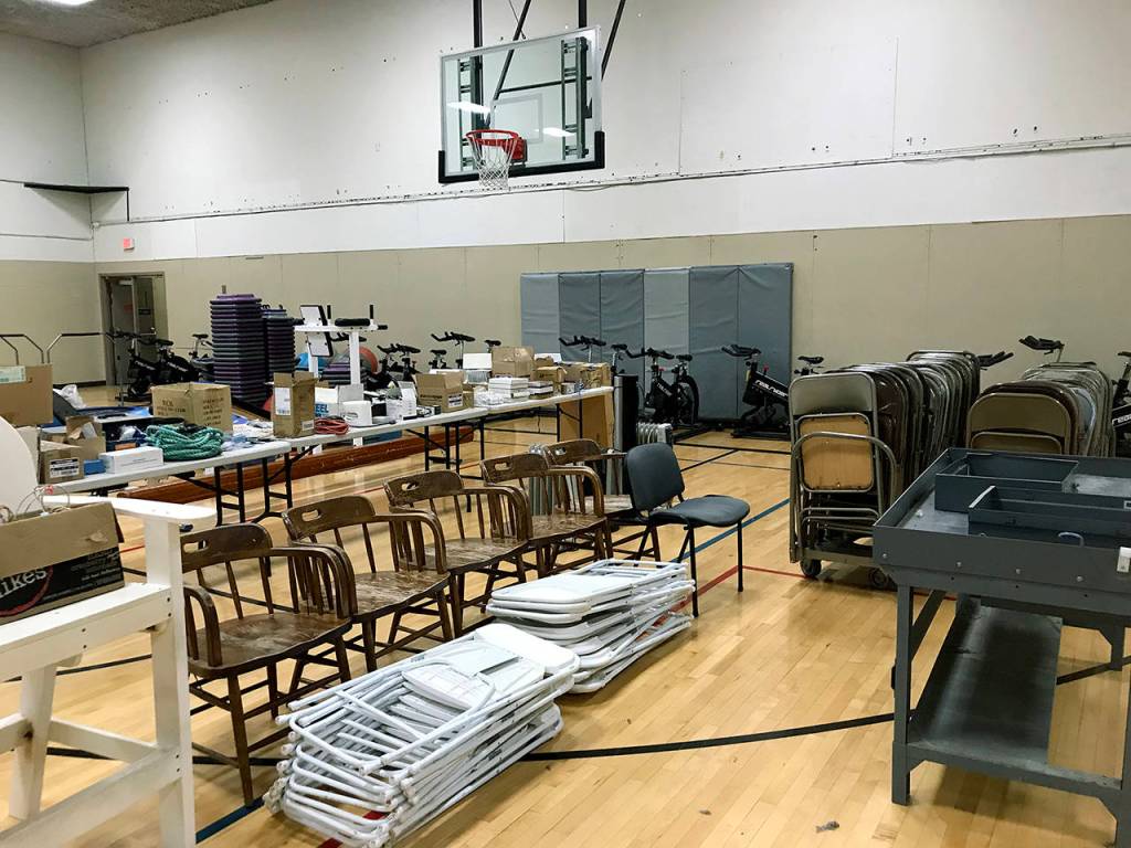 Extra equipment, including chairs and exercise bikes, is stored in a gym at the former Everett YMCA. Its all going to be up for sale at a garage sale next month. (Stephanie Davey / The Herald)