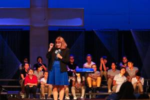 Northshore Christian Academy Superintendent Holly Leach was among school staff who went to Washington, D.C., last week to accept a National Blue Ribbon School award. The middle school choir, on stage with Leach, performed during a celebration Wednesday. (Dan Bates / The Herald)