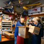 Richard Hunt, owner of the Edmonds Hobby Shop, helps Jan Schlameus with an appraisal of a train set from her youth. (Kevin Clark / The Herald)
