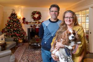 Bill and JJ Leese stand in the living room of their home on Friday, Nov. 15, 2019 in Everett, Wash. The well traveled couples house will be part of the Holiday Home Tour in Everett. (Andy Bronson / The Herald)