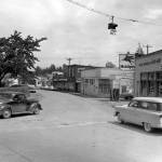 Old downtown Lake Stevens. Included in this image are the Lake Stevens Beauty shop, Irenes Coffee Shop, a Mobilgas station and the Lake Stevens Co-op. On the side of the Co-op building is a sign-post with seven signs pointing towards the direction of and number of miles to nearby towns. (Jim Leo / The Herald, 1955)