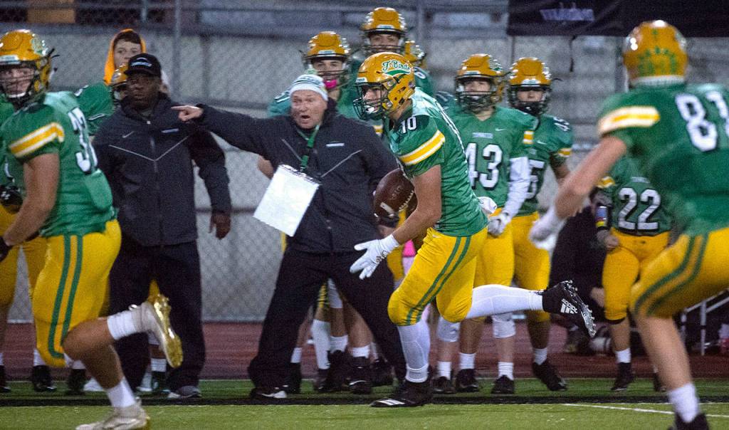 Tumwater defensive end Ryan Otton (center) returns an interception during a 2A state playoff game against Franklin Pierce on Nov. 15 at Tumwater District Stadium. (Tony Overman / The Olympian)
