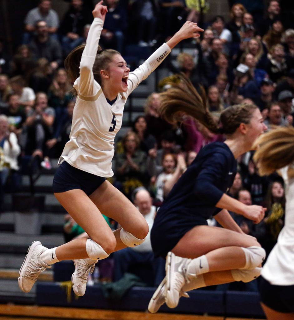 Arlingtons Emily Mekelburg celebrates her match winning ace against Oak Harbor on Oct. 24 at Arlington High School. Arlington won in straight sets. (Kevin Clark / The Herald)