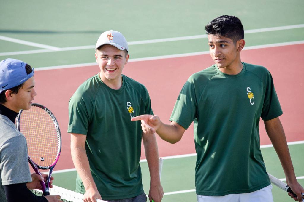 Shorecrests Ben Silber (middle) and Zaid Khan (right) talk to their opponents, Shintaro Wilcox and Preston Pierce, from Stanwood after winning the 3A Northwest District Tournament doubles final Oct. 30 at Arlington High School. (Katie Webber / The Herald)