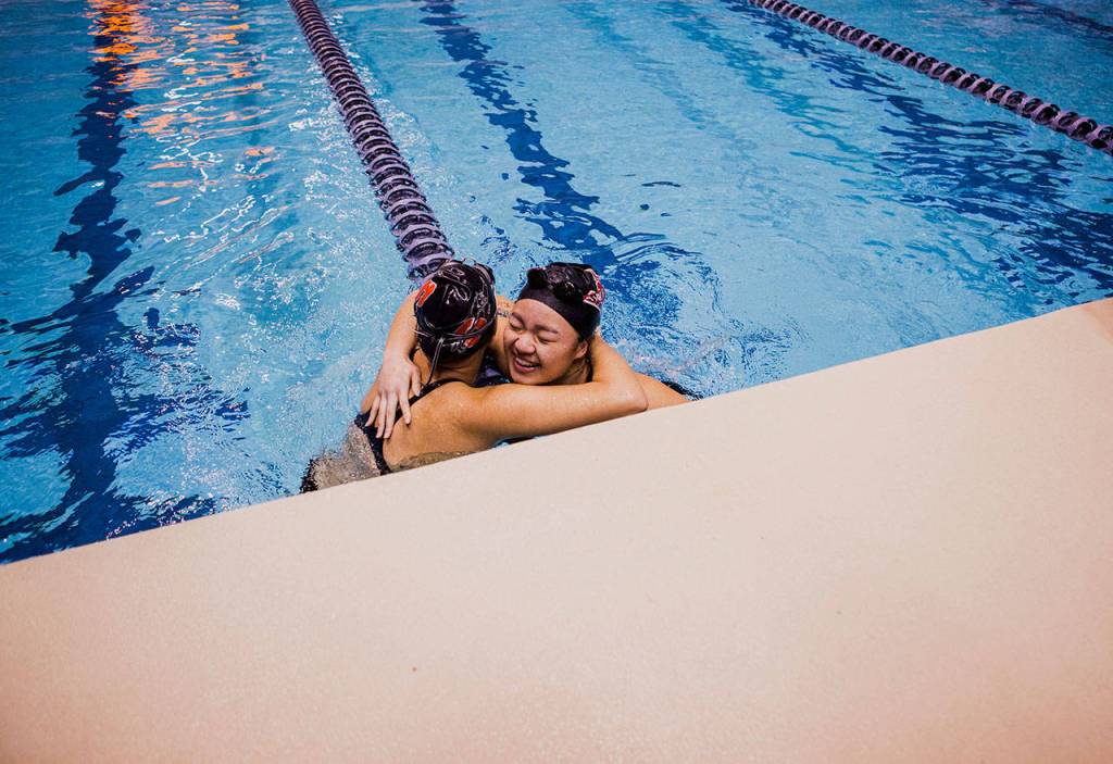 Stanwoods Jetlynn Hau hugs Snohomishs Mieko Schwartzmiller after their 100 yard breaststroke race during the WIAA 2018 State Swim & Dive Championships on Saturday, Nov. 10, 2018 in Federal Way, Wa. (Olivia Vanni / The Herald)