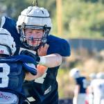 Senior Jacob Anderson pushes past the offense while practing defensive plays at Glacier Peak High School on Tuesday, Aug. 27. (Katie Webber / The Herald)