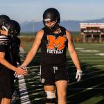 Gavin Monroe high-fives his teammates during football practice at Monroe High School on Wednesday, Aug. 28, 2019 in Monroe, Wash. (Olivia Vanni / The Herald)