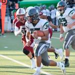 Junior running back Victor Martinez runs against the Cascade defense on Friday, Sept. 20 at Everett Memorial Stadium. (Katie Webber / The Herald)