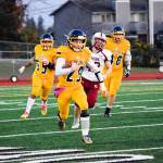 Junior quarterback Jackson Cole runs for a first down against Cascade on Friday, Oct. 25 at Goddard Stadium in Everett. (Katie Webber / The Herald)