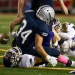 Lake Stevens Junior Robinson (bottom) and Lake Stevens Drew Carter (right) force a fumble by Glacier Peaks Ryan Black Friday night at Veterans Memorial Stadium in Snohomish on October 11, 2019. (Kevin Clark / The Herald)