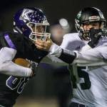 Kamiaks Ben Farrara and Jacksons Jack Barclay grab each others facemasks during the game on Nov. 1, 2019 in Everett, Wash. (Olivia Vanni / The Herald)