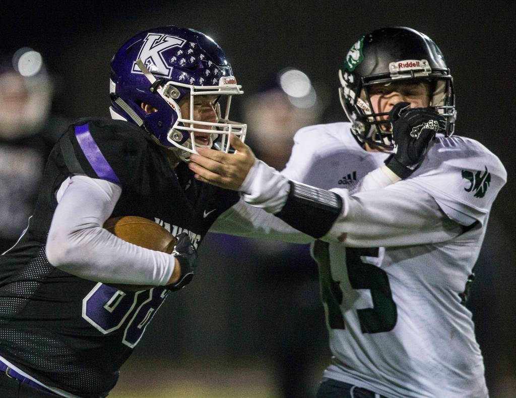 Kamiaks Ben Farrara and Jacksons Jack Barclay grab each others facemasks during the game on Nov. 1, 2019 in Everett, Wash. (Olivia Vanni / The Herald)