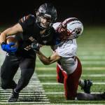 Monroe’s Efton Chism III is tackled during the 4A playoff game against Mount Si on Nov. 9, 2019 in Monroe, Wash. (Olivia Vanni / The Herald)