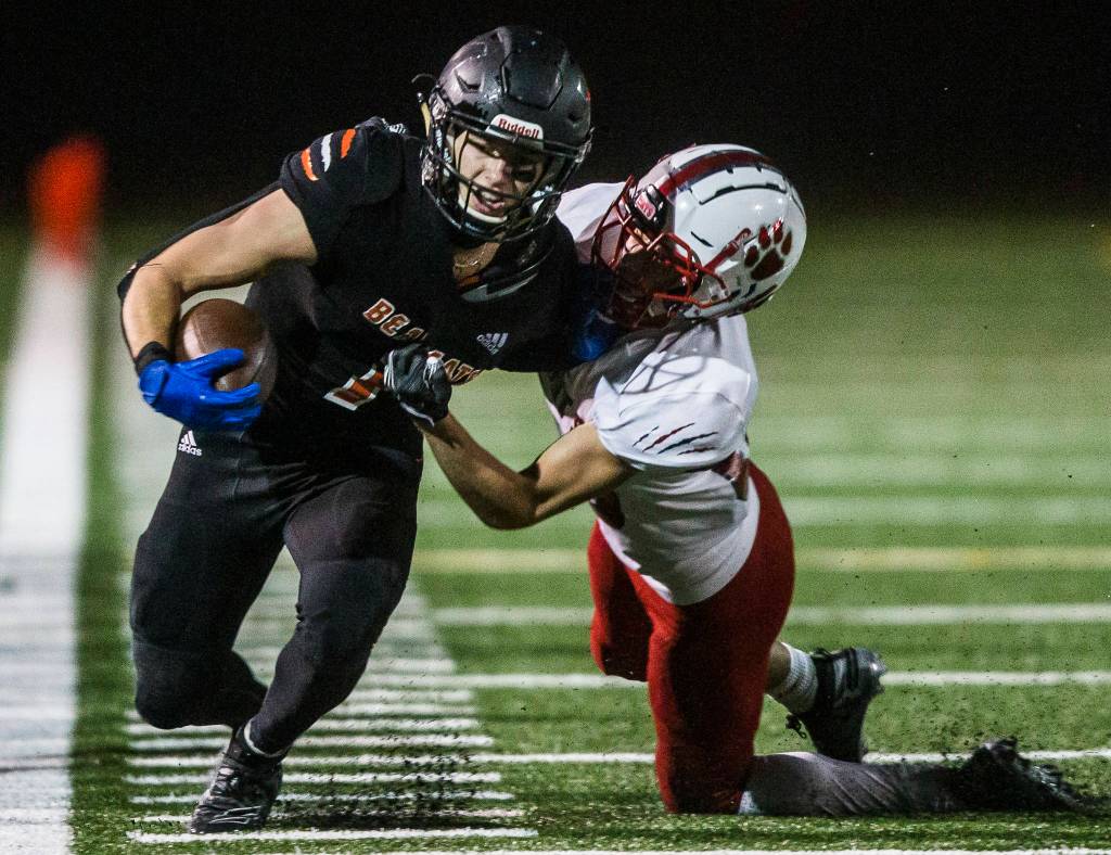 Monroe’s Efton Chism III is tackled during the 4A playoff game against Mount Si on Nov. 9, 2019 in Monroe, Wash. (Olivia Vanni / The Herald)